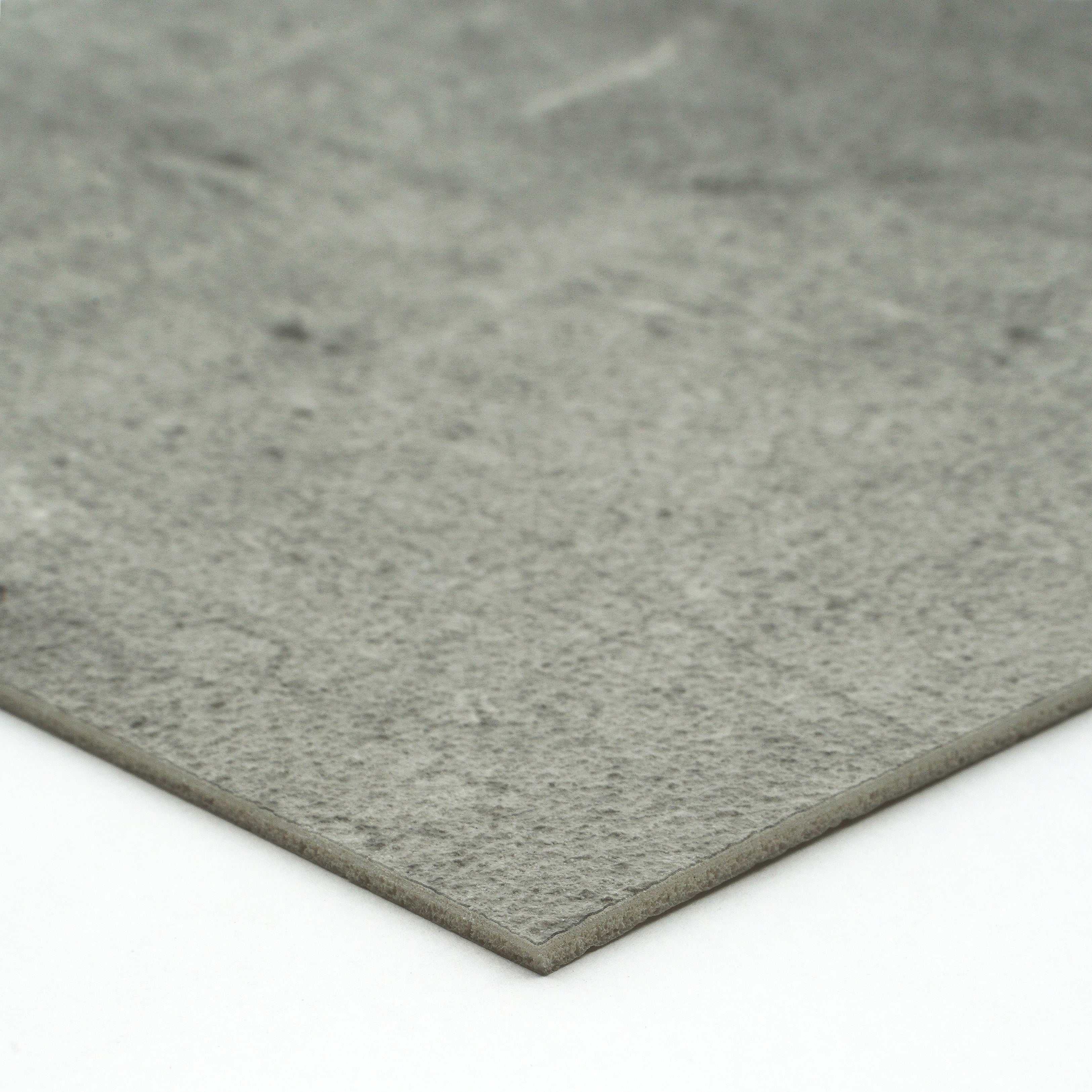 Gray textured stone slab, ideal for flooring or countertops, made from durable composite material.